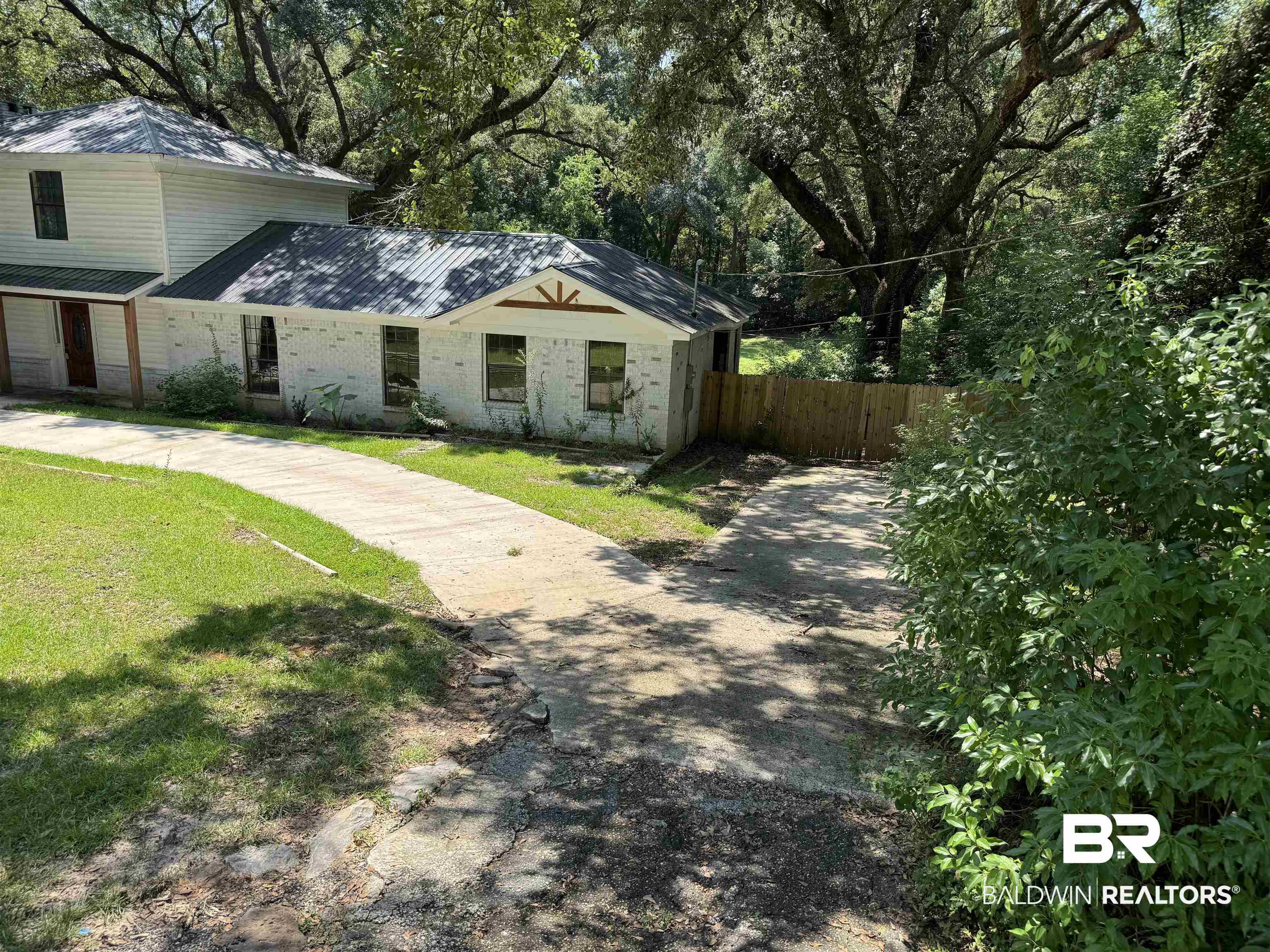 1302 Oak Street Daphne, AL 36526 - Photo 3 of 34 View of front of home with brick siding and view of scattered trees
