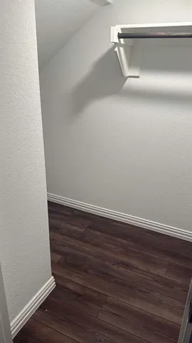 a view of a room with wooden floor