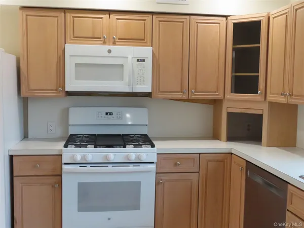 a kitchen with granite countertop cabinets washer and dryer