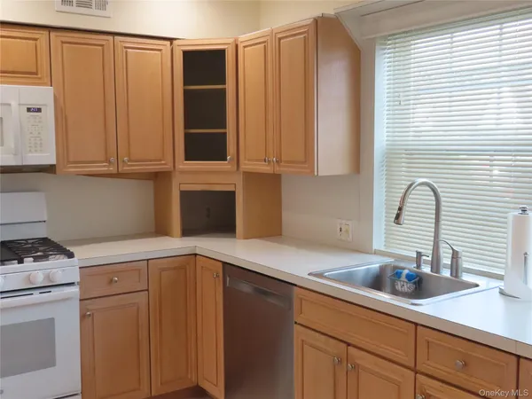 a kitchen with a sink cabinets and utility