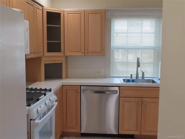 a kitchen with cabinets and window