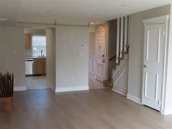 an empty room with windows and cabinet