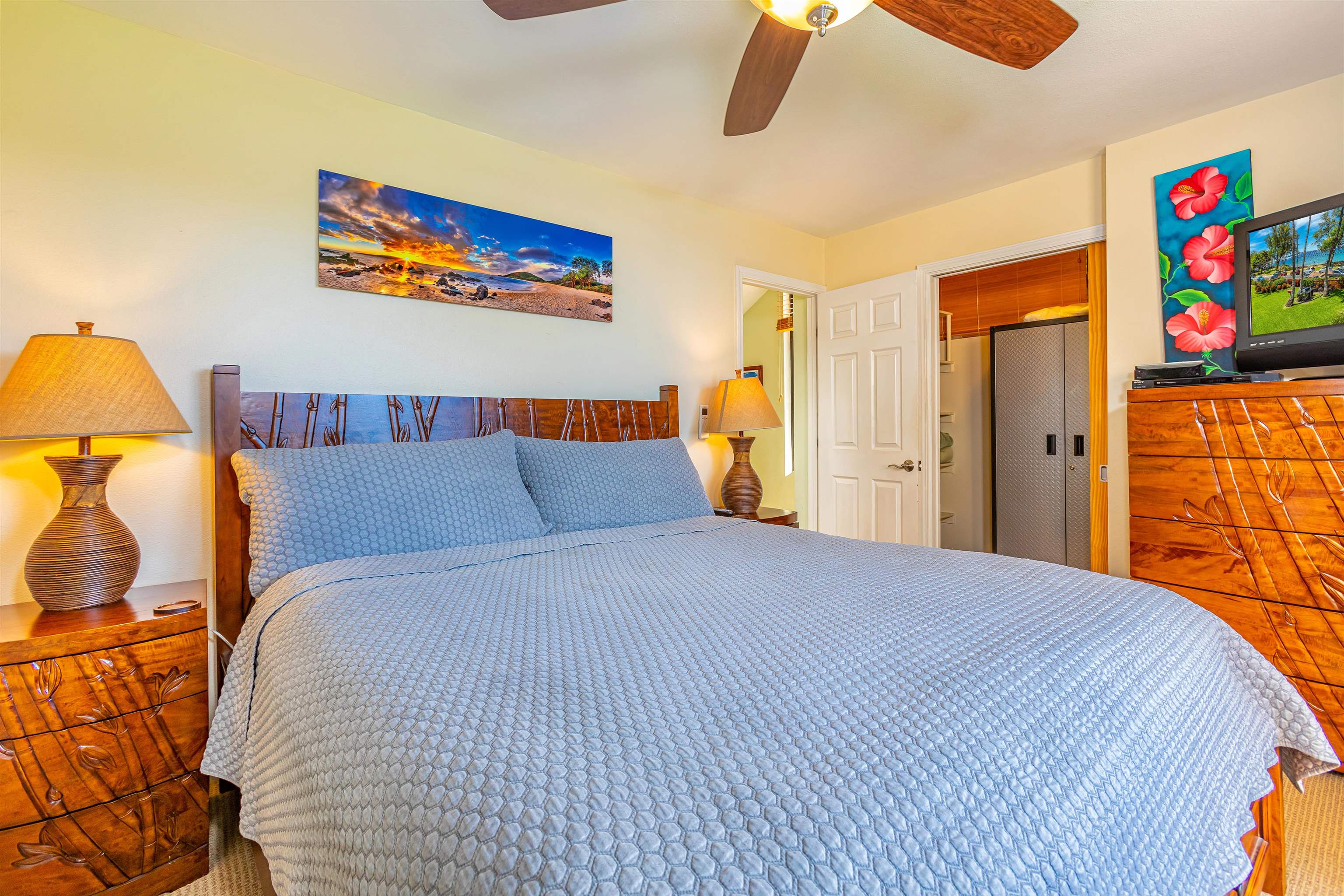 2381 South Kihei Road, Unit C109 Kihei, HI 96753 - Photo 13 of 25 a bedroom with a bed and painting on the wall