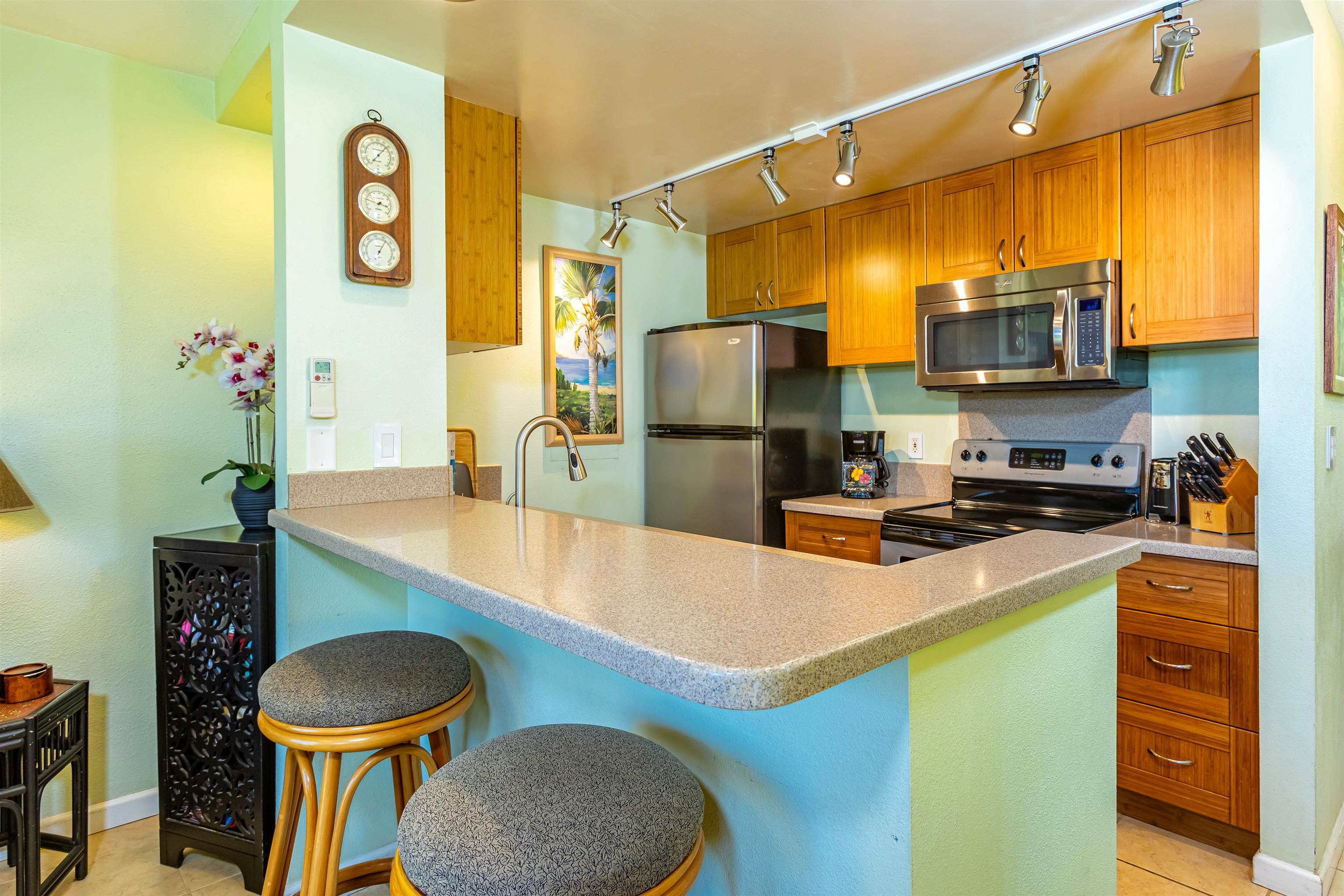 2381 South Kihei Road, Unit C109 Kihei, HI 96753 - Photo 2 of 25 a kitchen with stainless steel appliances granite countertop a sink a stove and a refrigerator