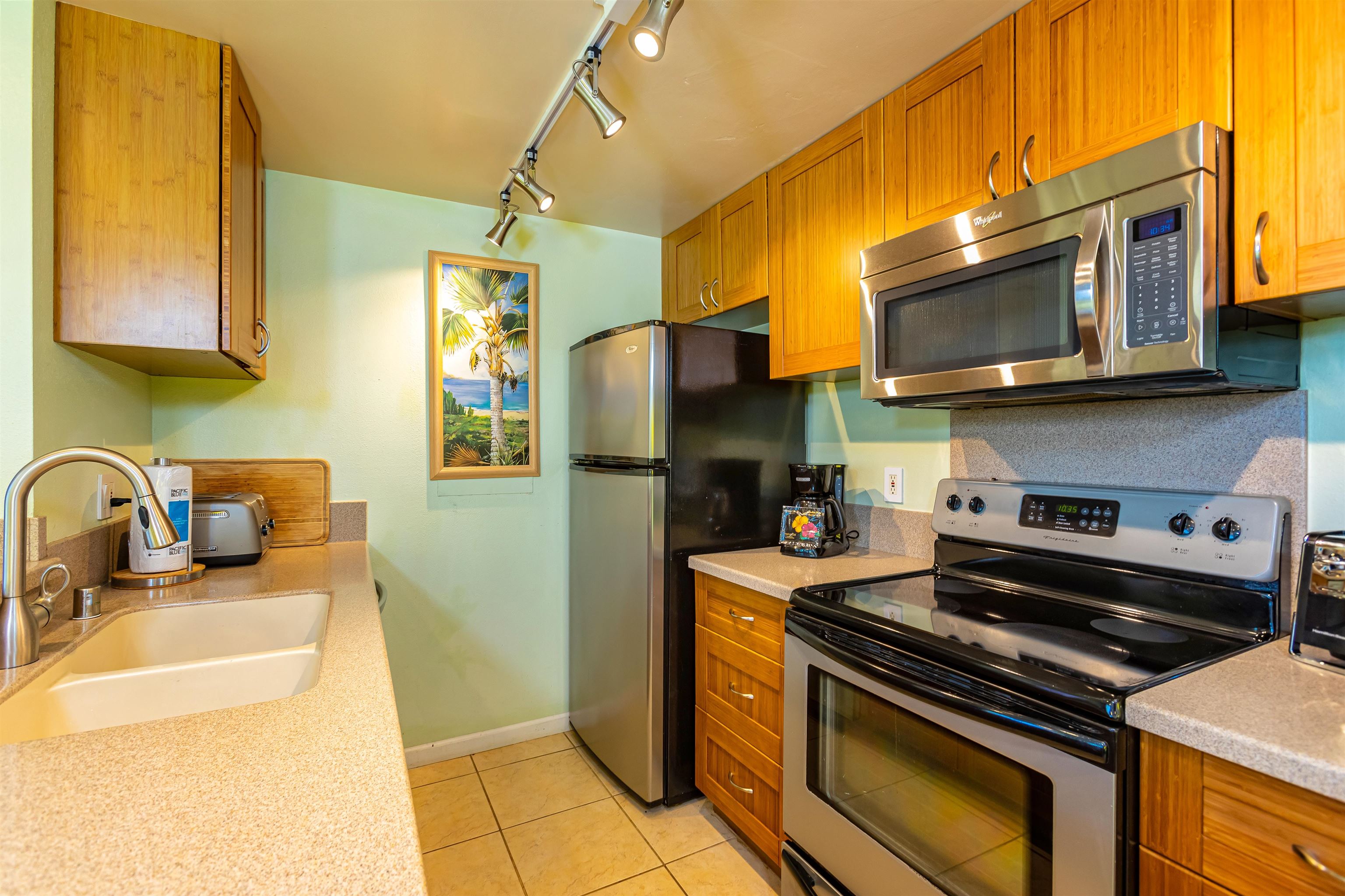 2381 South Kihei Road, Unit C109 Kihei, HI 96753 - Photo 3 of 25 a kitchen with stainless steel appliances granite countertop a stove and a microwave