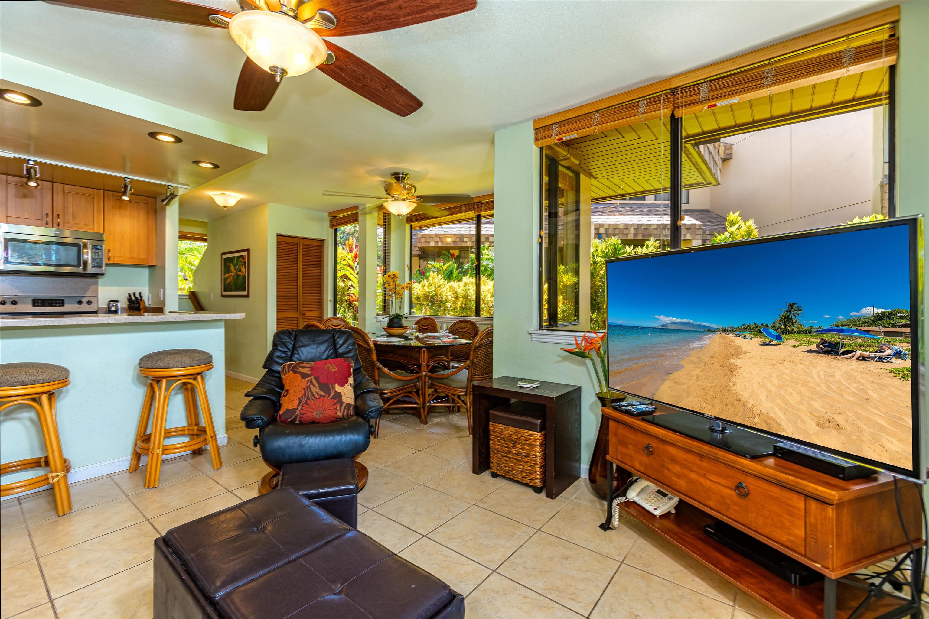 2381 South Kihei Road, Unit C109 Kihei, HI 96753 - Photo 9 of 25 a room with chandelier furniture and a flat screen tv