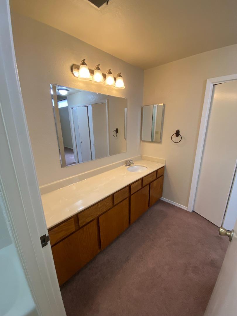 1051 Padre Drive, Unit 7 Salinas, CA 93901 - Photo 17 of 22 a bathroom with a double vanity sink and mirror