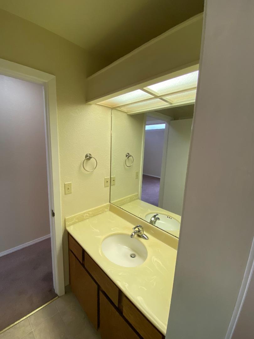 1051 Padre Drive, Unit 7 Salinas, CA 93901 - Photo 18 of 22 a bathroom with a sink and a mirror