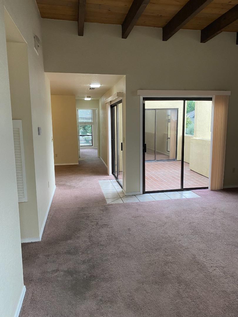 1051 Padre Drive, Unit 7 Salinas, CA 93901 - Photo 5 of 22 an empty room with sliding door and windows