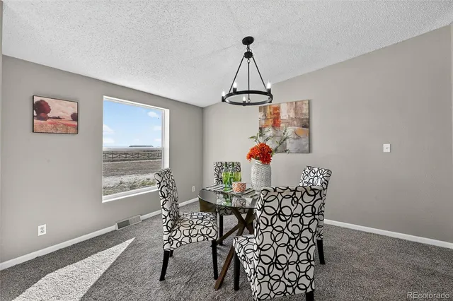 a view of a dining room with furniture window and outside view