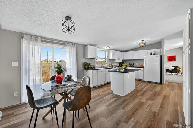 a kitchen with stainless steel appliances a stove refrigerator sink and cabinets