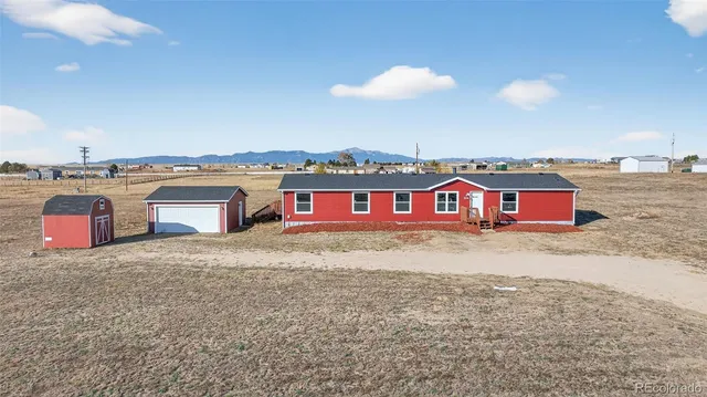a view of a swimming pool with a yard