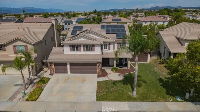 an aerial view of a house with a yard