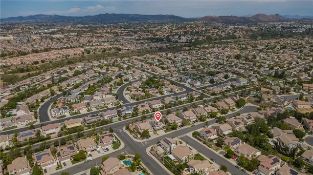 a view of a backyard with table and chairs under an umbrella