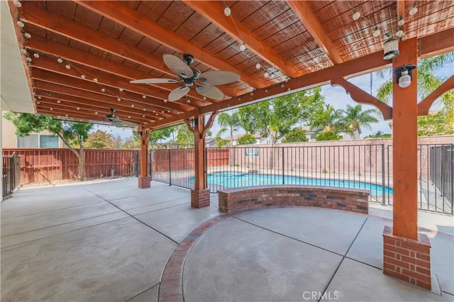 a view of a livingroom with a workspace and a chandelier fan