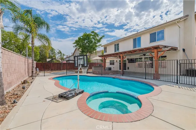 a kitchen with a refrigerator a stove top oven a sink dishwasher and white cabinets with wooden floor