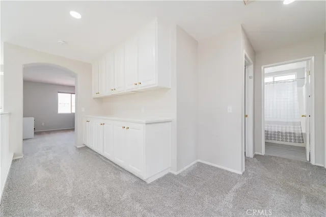 a living room with furniture white walls and wooden floor