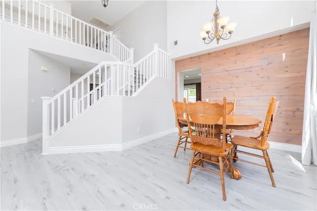 an empty room with fan and entrance