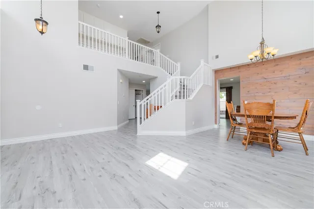 a view of a hallway with wooden floor and stairs