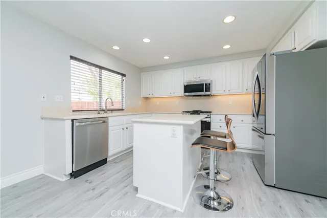 a large bed sitting in a bedroom next to a window
