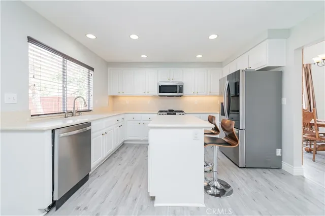 a bathroom with a sink a large mirror and shower