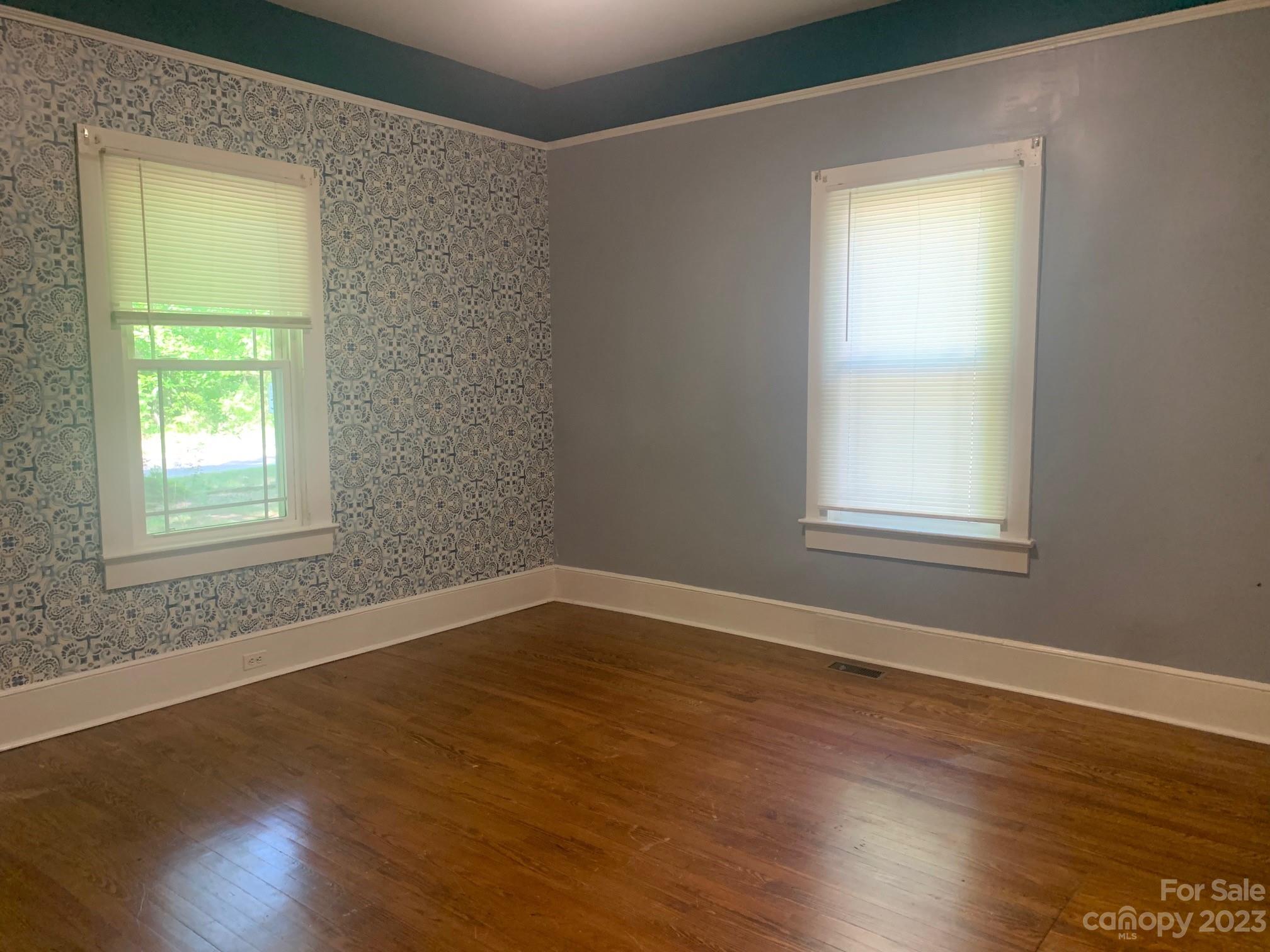 5616 Charlie Walker Road Kannapolis, NC 28081 - Photo 6 of 13 a view of an empty room with wooden floor and a window