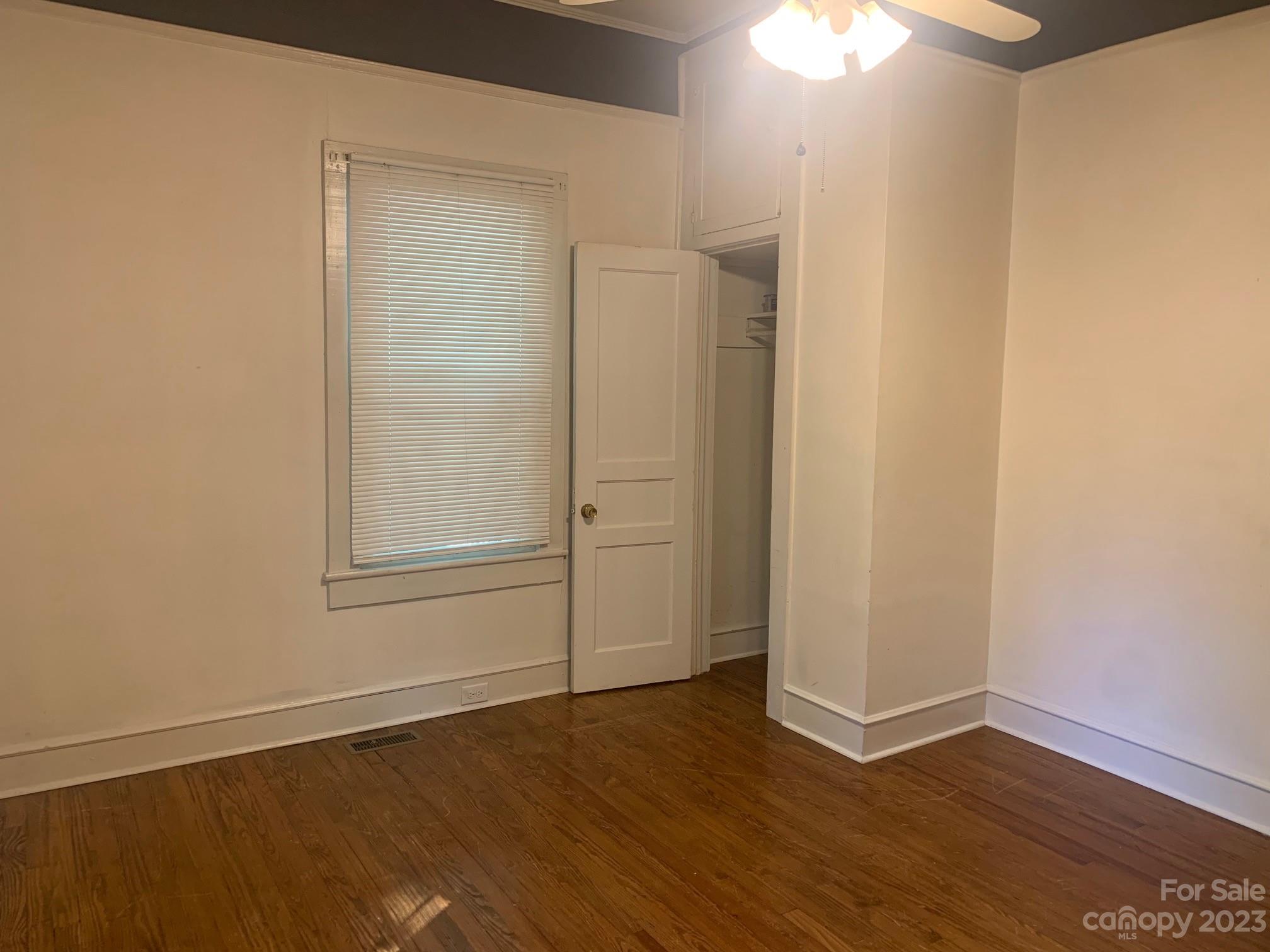 5616 Charlie Walker Road Kannapolis, NC 28081 - Photo 8 of 13 an empty room with wooden floor and closet