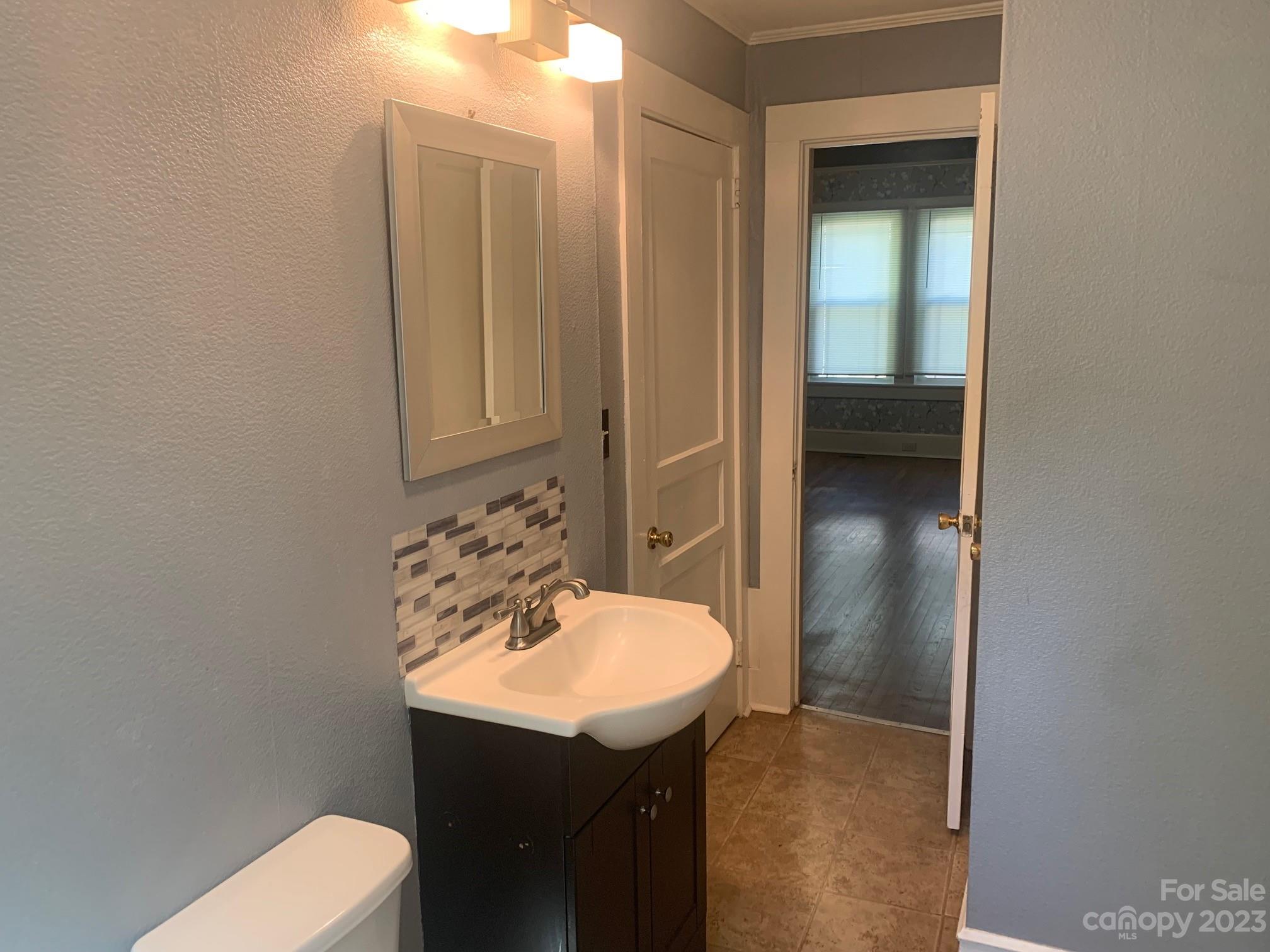 5616 Charlie Walker Road Kannapolis, NC 28081 - Photo 9 of 13 a bathroom with a sink a toilet and shower