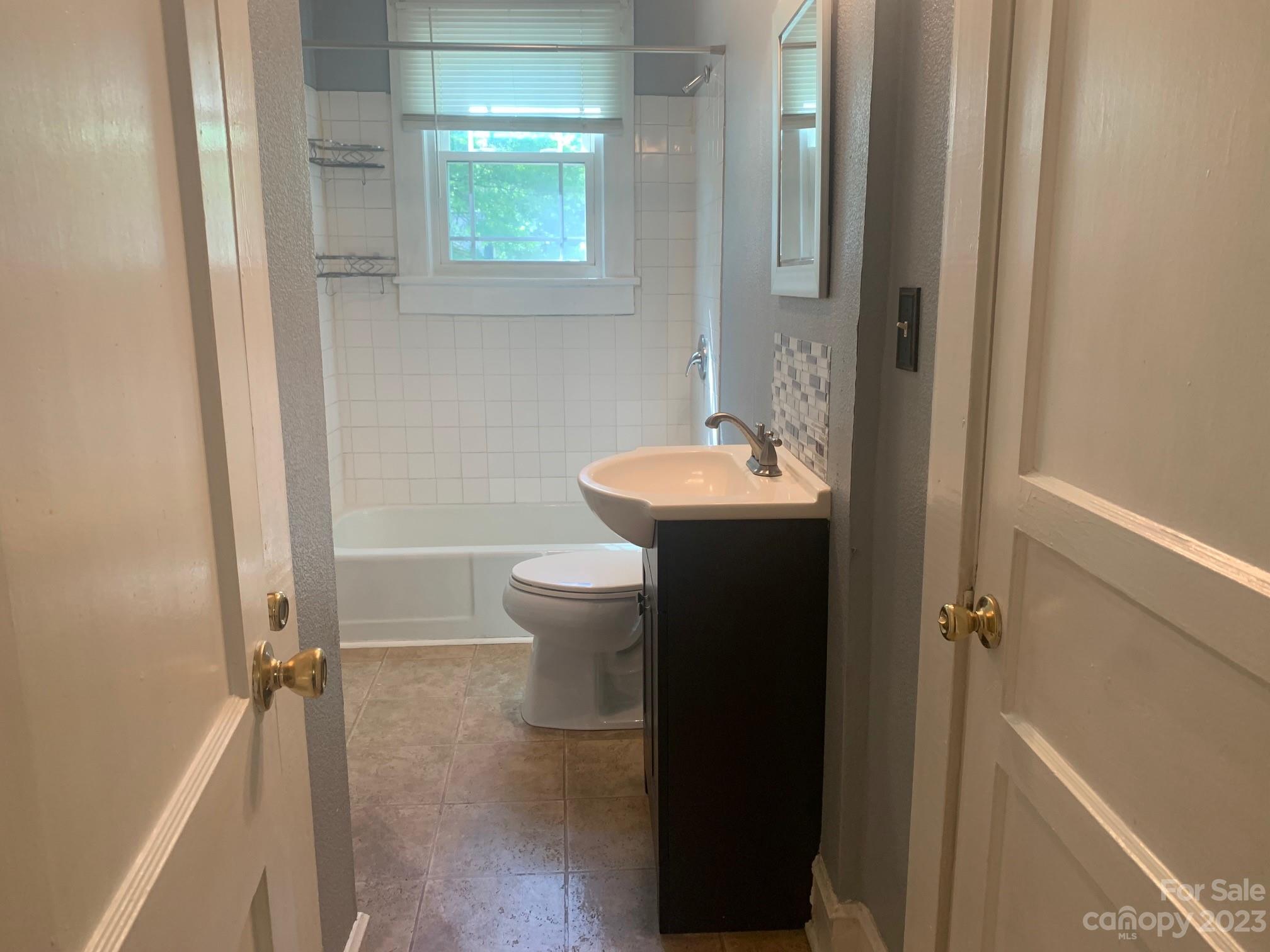 5616 Charlie Walker Road Kannapolis, NC 28081 - Photo 10 of 13 a bathroom with a sink toilet and shower