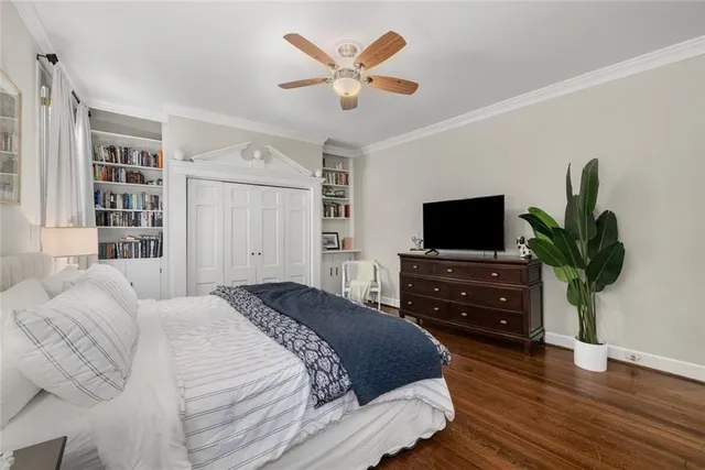 a bedroom with a bed window and a flat screen tv