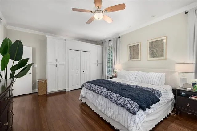 a spacious bedroom with a bed and a potted plant