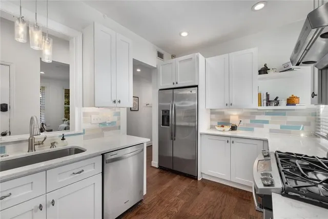 a kitchen with a sink stainless steel appliances and cabinets