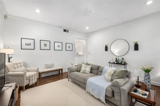a living room with furniture and a mirror