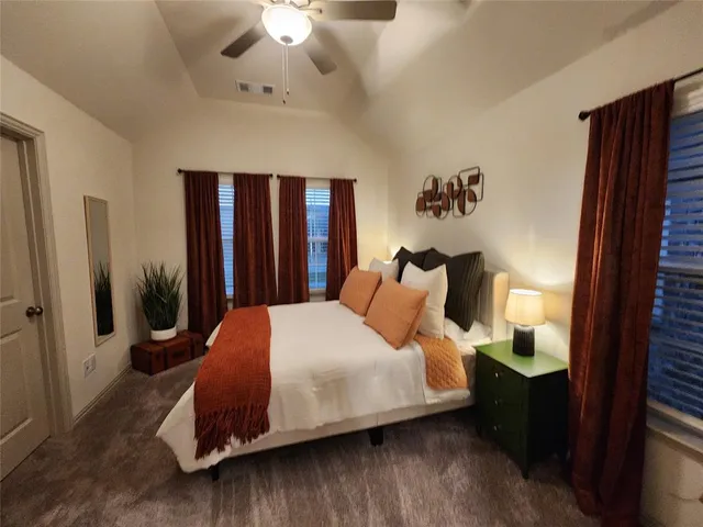 a bed sitting in a bedroom next to a window