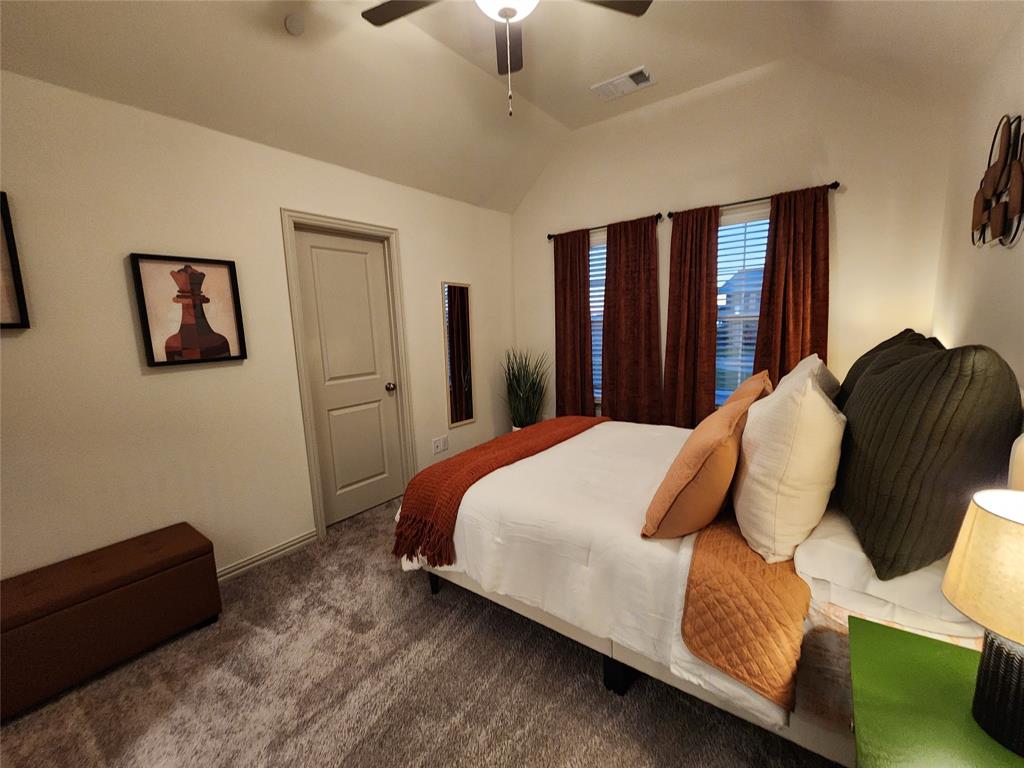 4708 Haltom Road Haltom City, TX 76117 - Photo 22 of 29 a bed sitting in a bedroom next to a window