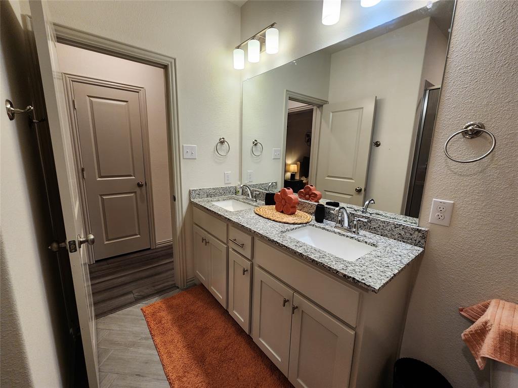 4708 Haltom Road Haltom City, TX 76117 - Photo 26 of 29 a bathroom with a granite countertop sink and a mirror
