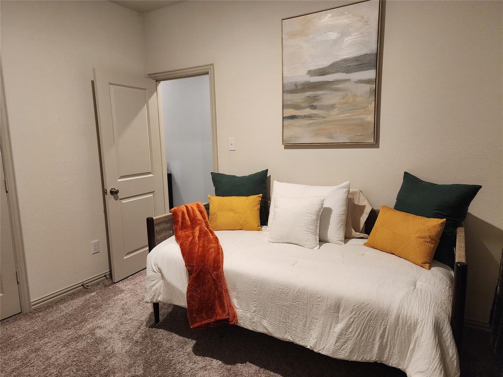 4708 Haltom Road Haltom City, TX 76117 - Photo 6 of 29 a bedroom with a bed and wooden floor