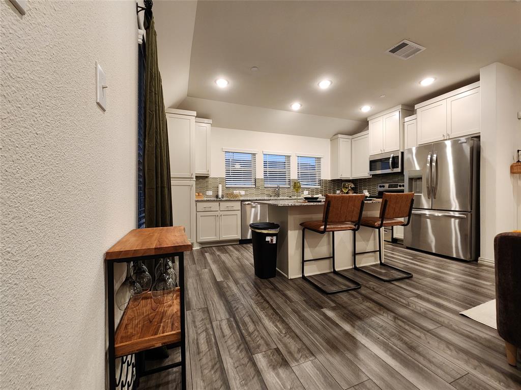 4708 Haltom Road Haltom City, TX 76117 - Photo 10 of 29 a kitchen with stainless steel appliances a refrigerator and a table