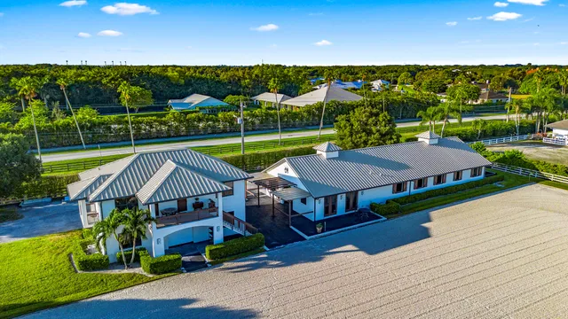 a view of a hallway with wooden floor and windows
