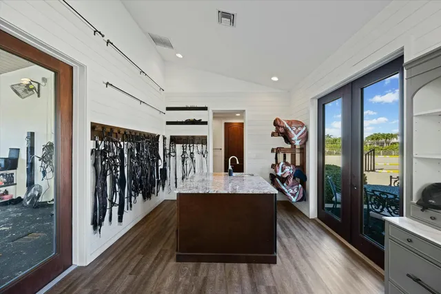a view of a white house with a yard and balcony