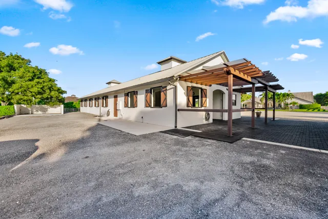a kitchen with stainless steel appliances kitchen island granite countertop a table chairs in it and wooden floors
