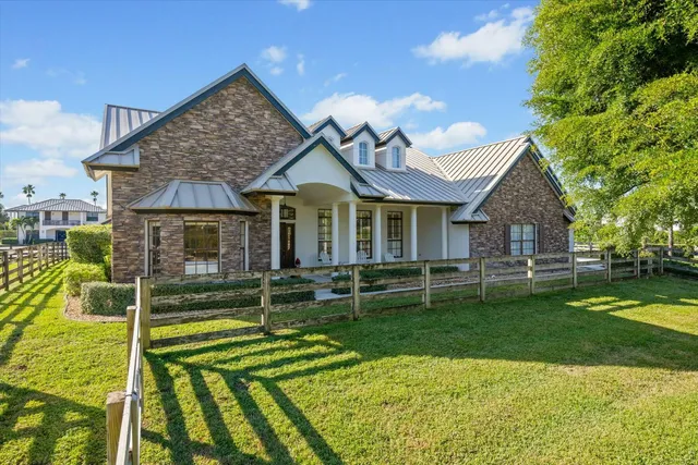 a bathroom with a granite countertop sink a mirror and a shower