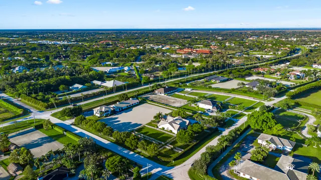 an aerial view of a house with a garden and swimming pool