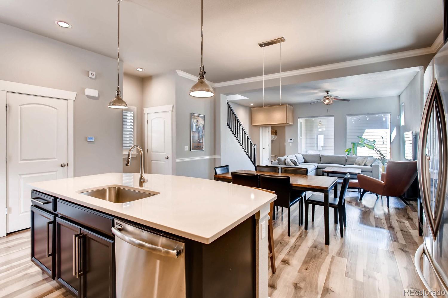 2858 Lima Street Denver, CO 80238 - Photo 12 of 28 a kitchen with a table chairs sink and wooden floor