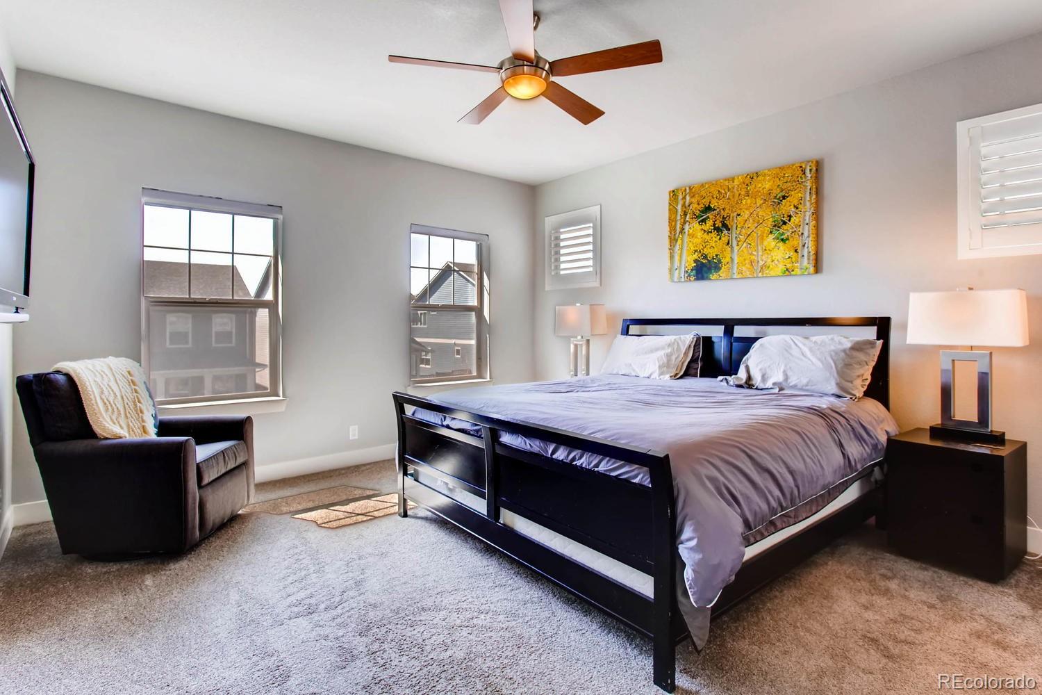 2858 Lima Street Denver, CO 80238 - Photo 14 of 28 a bedroom with a bed and a couch