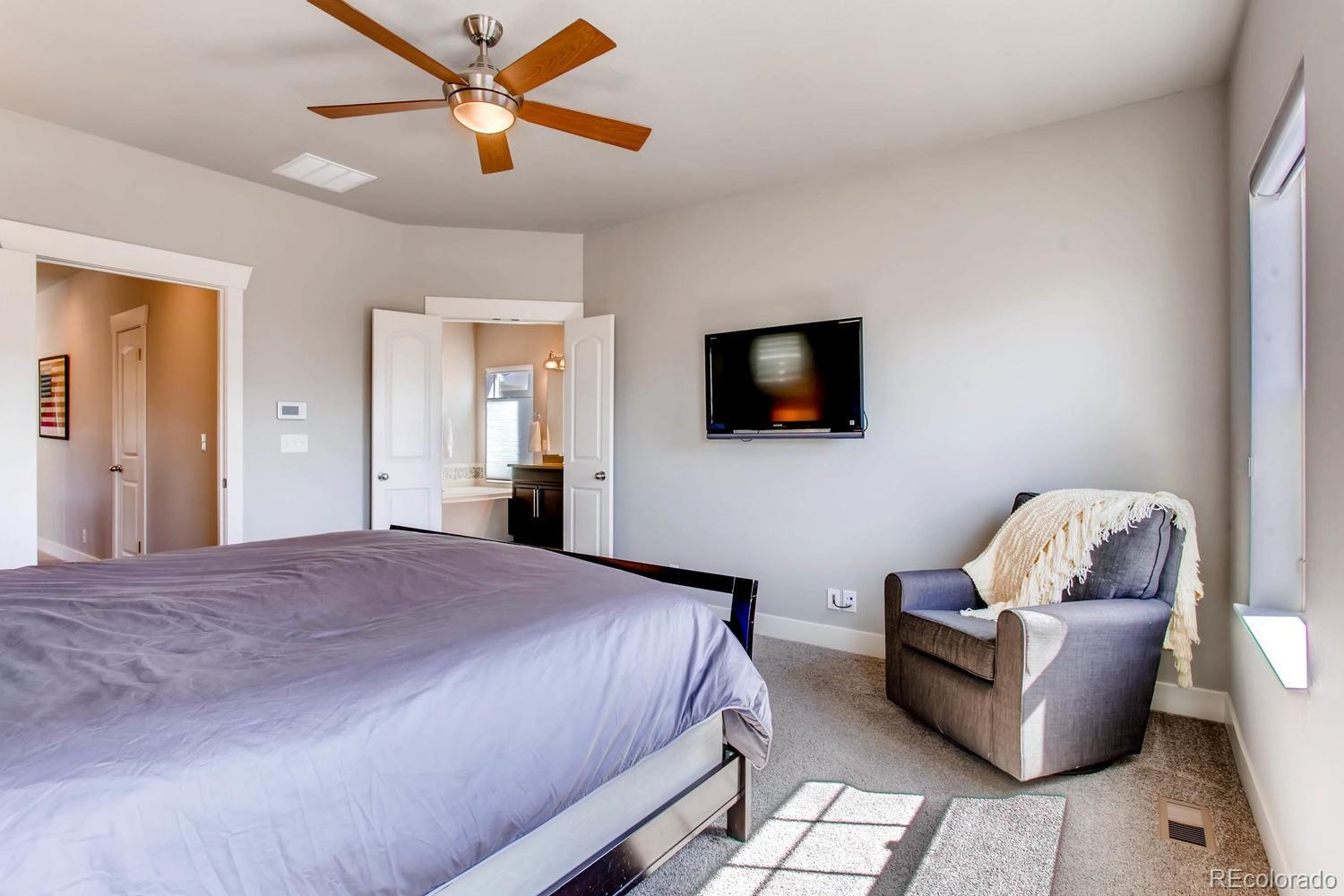 2858 Lima Street Denver, CO 80238 - Photo 15 of 28 a bedroom with bed and a flat screen tv