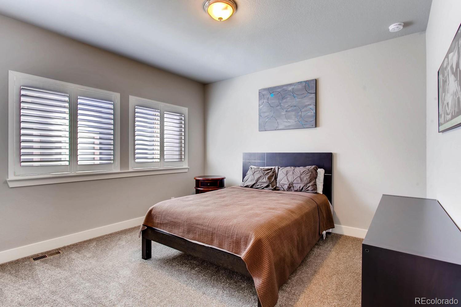 2858 Lima Street Denver, CO 80238 - Photo 17 of 28 a bedroom with a bed and a window