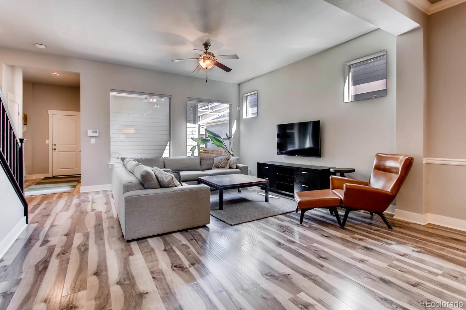 2858 Lima Street Denver, CO 80238 - Photo 4 of 28 a living room with furniture and a flat screen tv