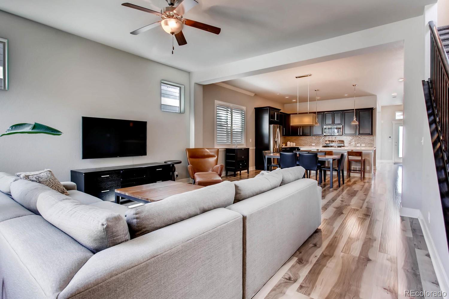 2858 Lima Street Denver, CO 80238 - Photo 5 of 28 a living room with furniture and a flat screen tv