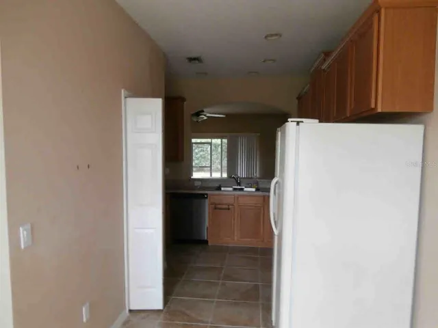 a kitchen with stainless steel appliances a refrigerator and a stove top oven